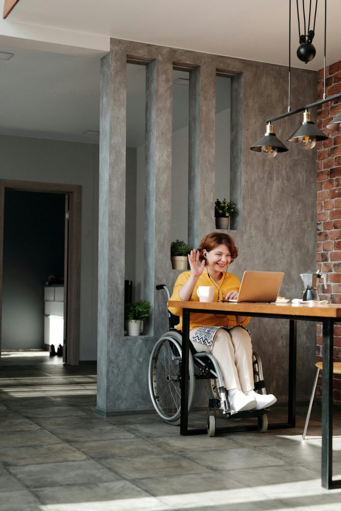 Woman in Orange Tank Top Sitting on Black Wheelchair